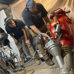 Two sewer ninjas team members performing a cleaning service to a customer's sewer