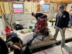 workers performing a CIPP in the basement of a residential home