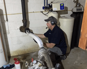 Sewer ninjas worker using a large machine to perform pipe cleaning for sewer backups